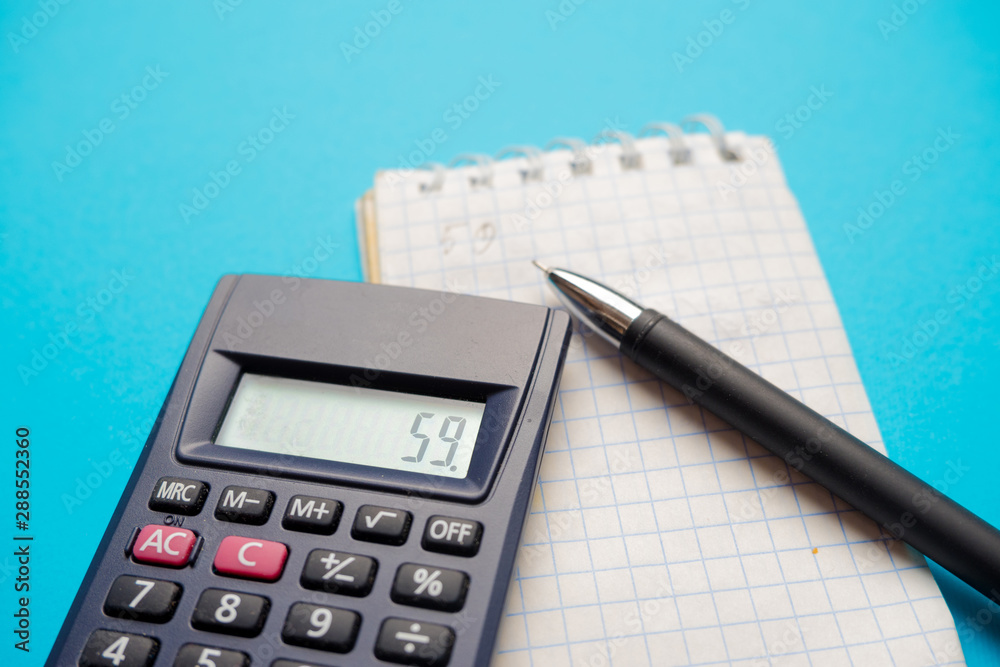 black office calculator, on a blue background black office calculator, on a blue background