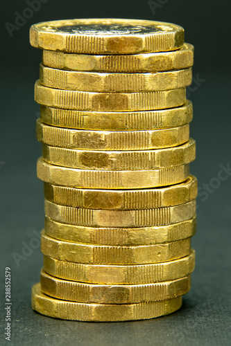 Stack of one British pound coins on a black background