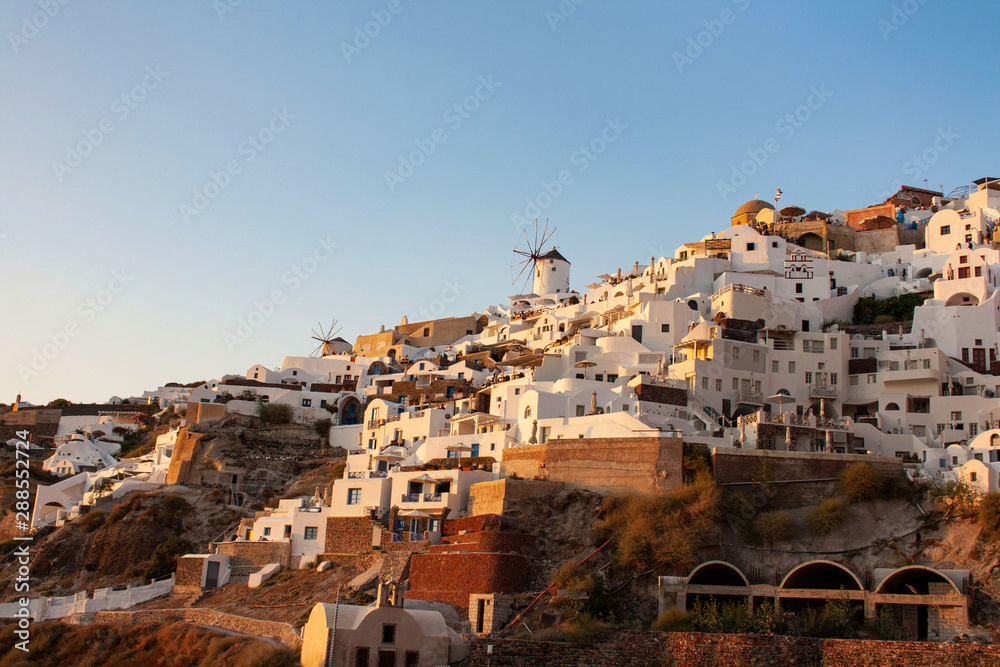 View of Oia the most famous village of Santorini Island in Greece with white houses and windmills