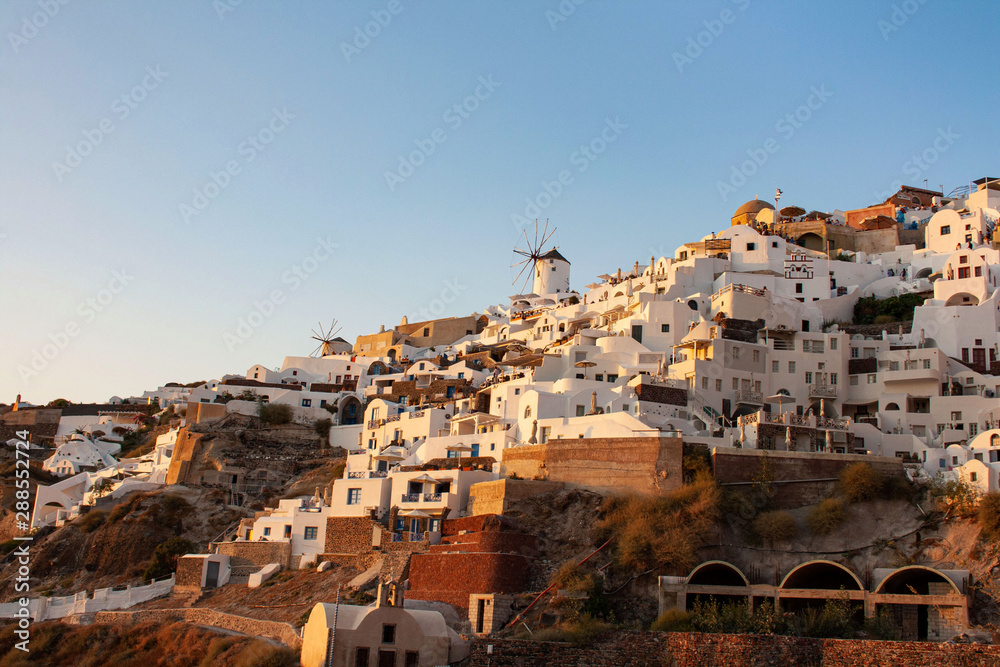 Fototapeta premium View of Oia the most famous village of Santorini Island in Greece with white houses and windmills
