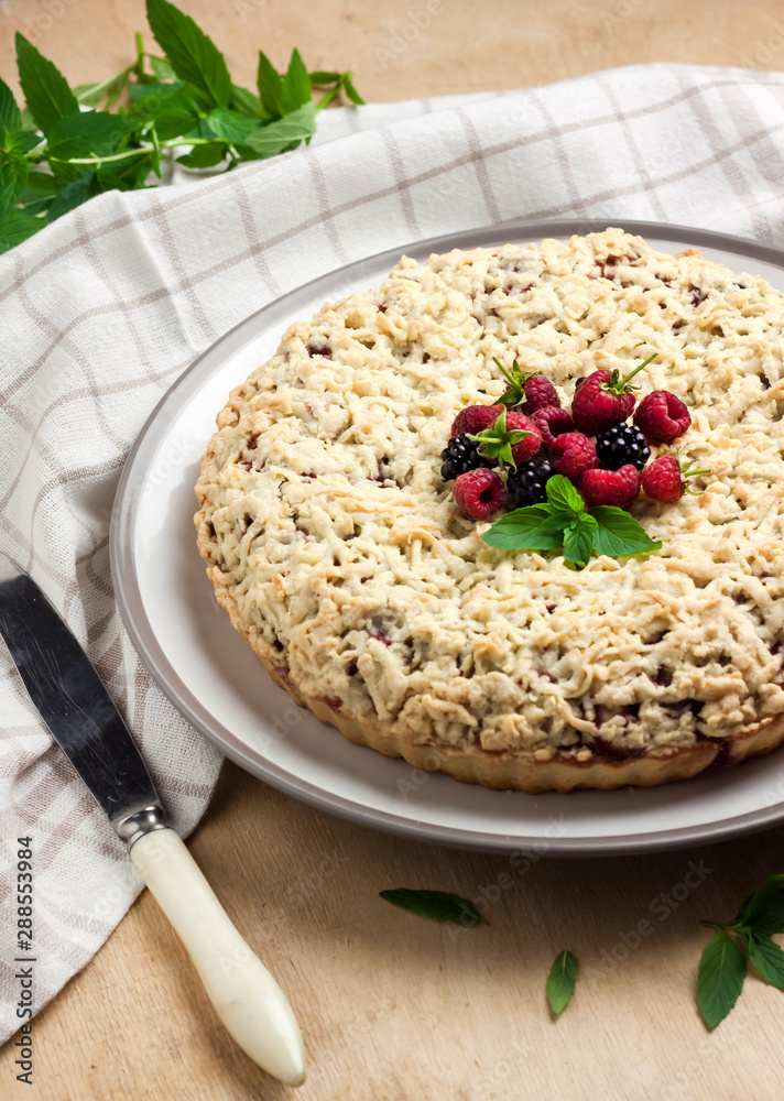 Berry shortcrust pie with crumble on a plate Berry shortcrust pie with crumble on a plate