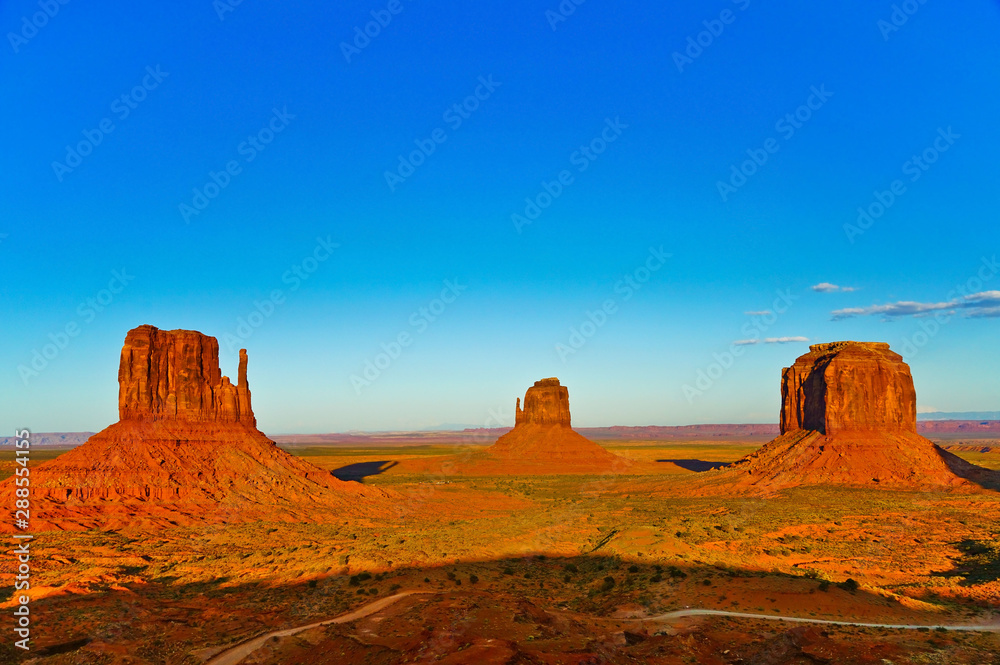 View of Monument Valley at sunset near the border of Arizona and Utah in Navajo Nation Reservation in USA. View of Monument Valley at sunset near the border of Arizona and Utah in Navajo Nation Reservation in USA.