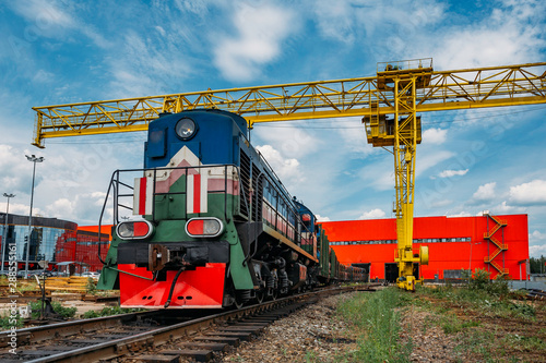 Bild auf Leinwand Freight train with cargo exits from warehouse