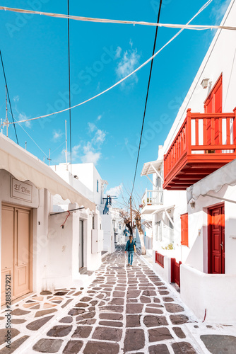 Typical Greek architecture in the white, cobbled alleys of Mykonos town, houses in the old town of Chora with colorful balconies and white churches, Cyclades, Greece