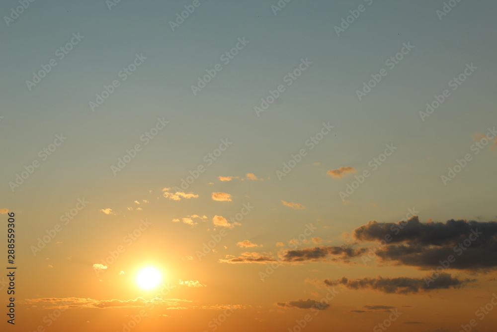 yellow and blue sunset in summer field