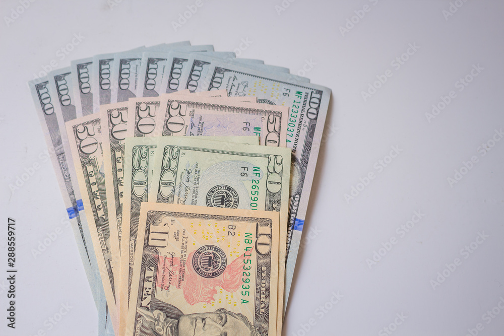 close up view of cash money dollars bills in amount. 100, 50, 20, 10