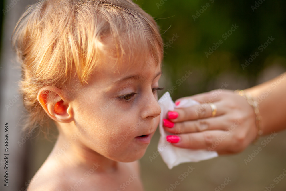 Cleaning baby face and skin with wet wipes tissue Cleaning baby face and skin with wet wipes tissue