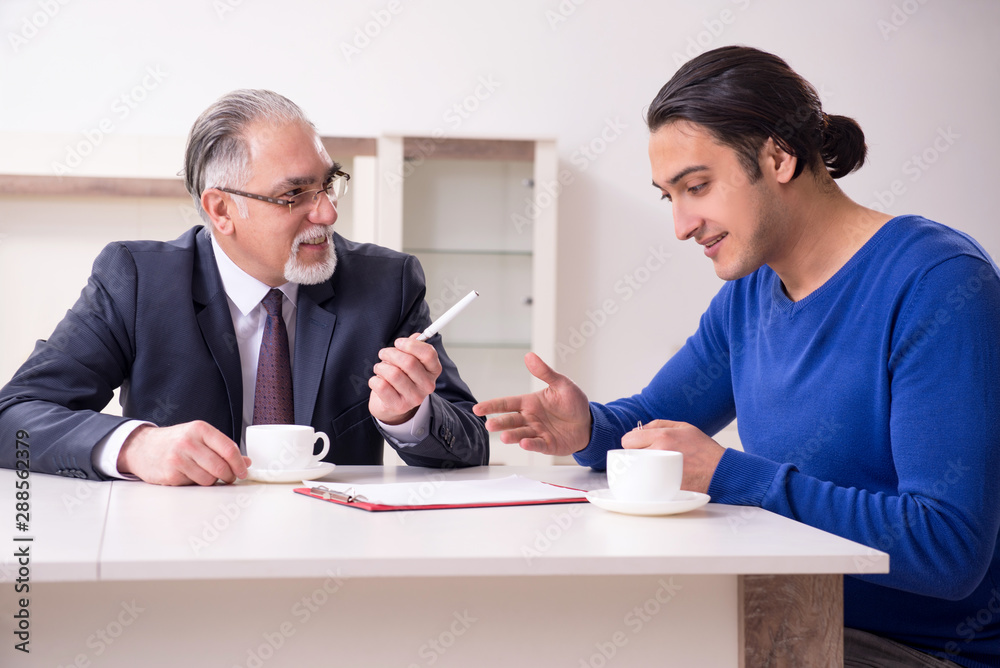 Male real estate agent and male client in the apartment Male real estate agent and male client in the apartment