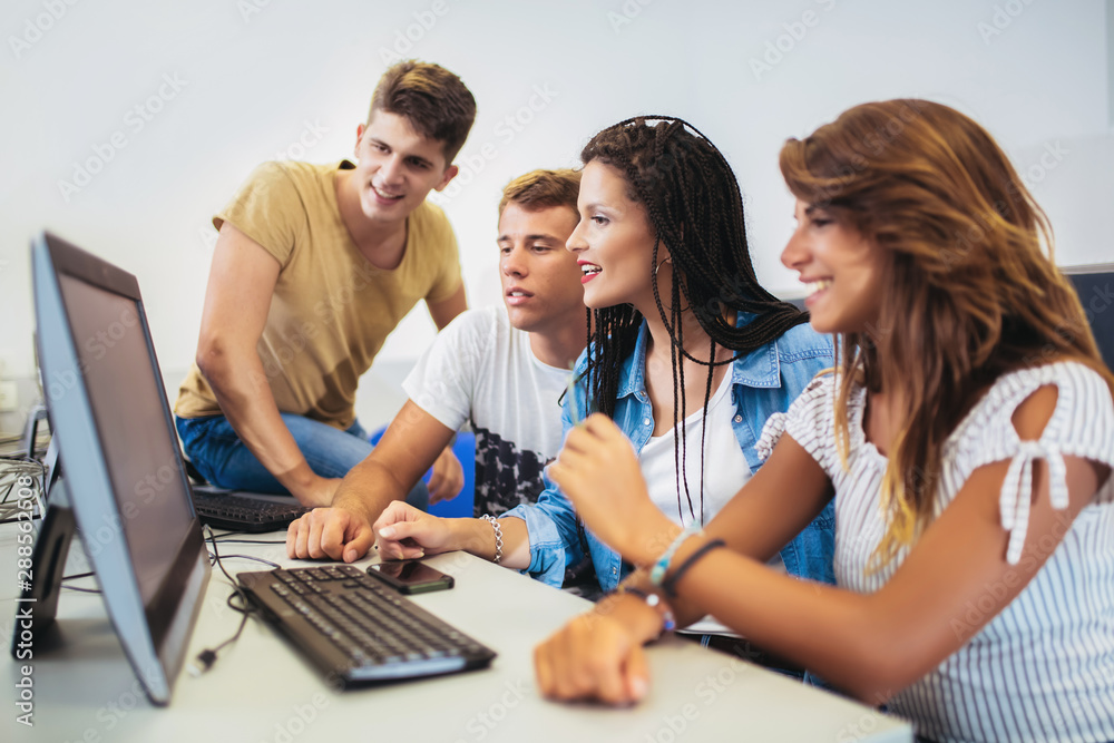College students sitting in a classroom, using computers during class. College students sitting in a classroom, using computers during class.