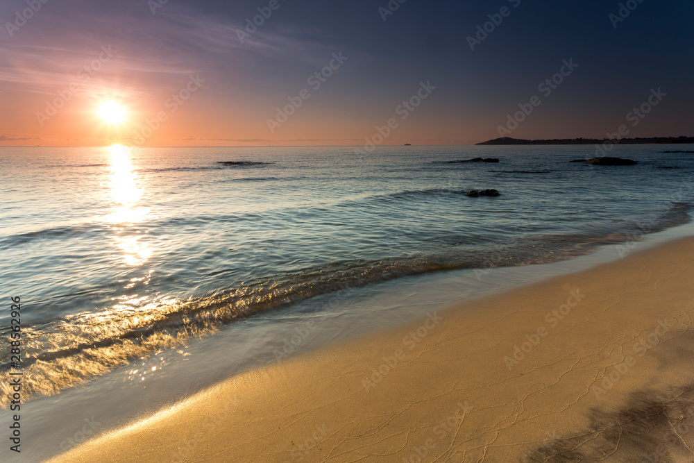 sunrise view at the Lake Malawi, waves rolling smoothly on the beach, Africa