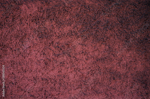 Empty dusty burgundy red textured surface.