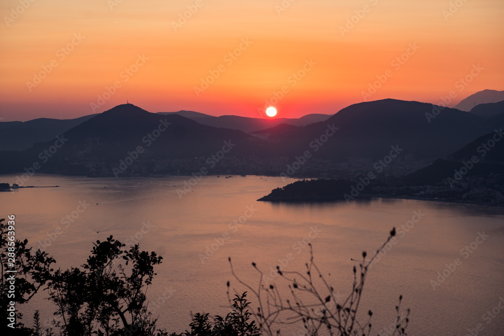 Sunset on the sea among the beautiful mountains, the Adriatic Sea. Montenegro.