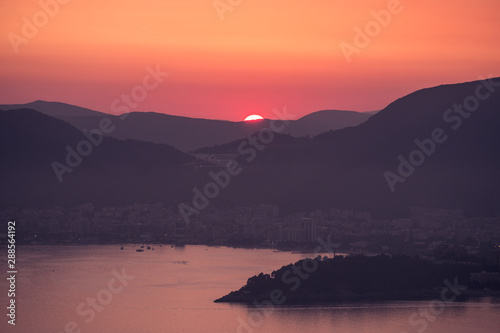 Sunset on the sea among the beautiful mountains  the Adriatic Sea. Montenegro.