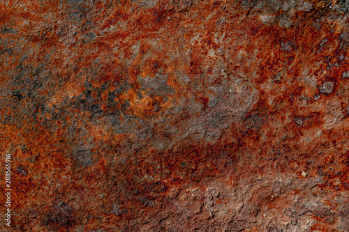 Rusty metal texture. Brown, red, orange and gray colours of rust. Rough surface. Background for text or design