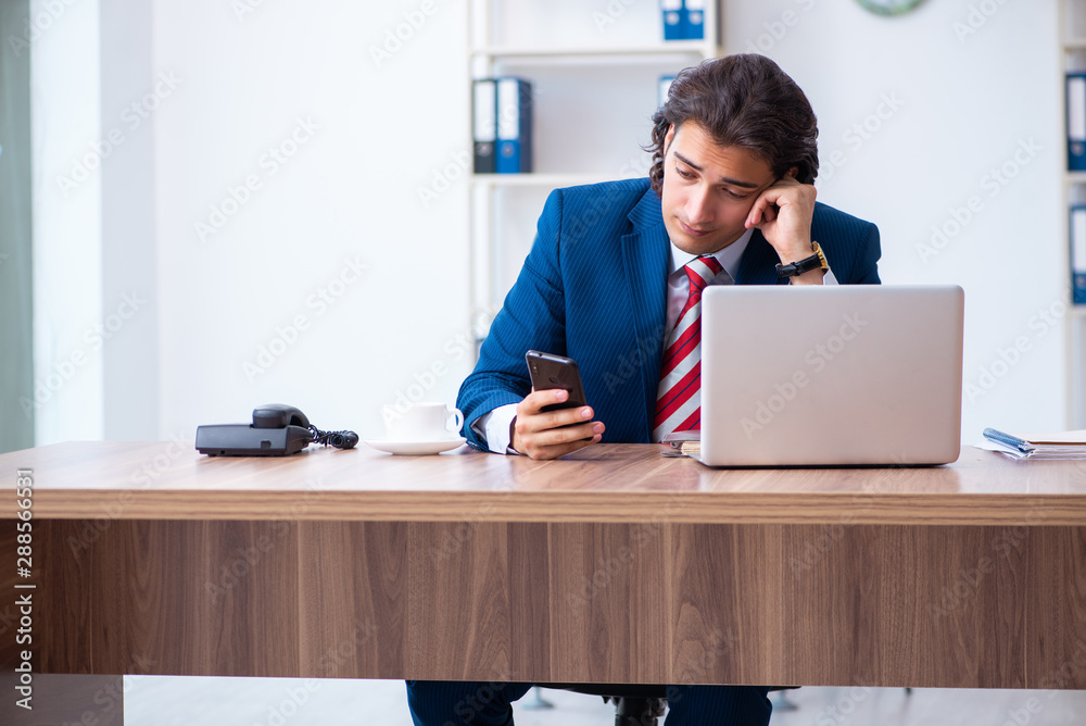 Young male businessman working in the office Young male businessman working in the office