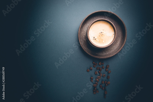Cup of coffee on a black background. top view with copy space. morning concept.