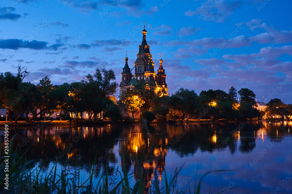 Russia. Peterhof. Night view of the Cathedral of St. Peter and Paul through Holguin Pond Russia. Peterhof. Night view of the Cathedral of St. Peter and Paul through Holguin Pond