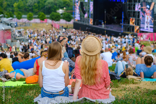 Fototapeta Naklejka Na Ścianę i Meble -  Couple is watching concert at open air music festival