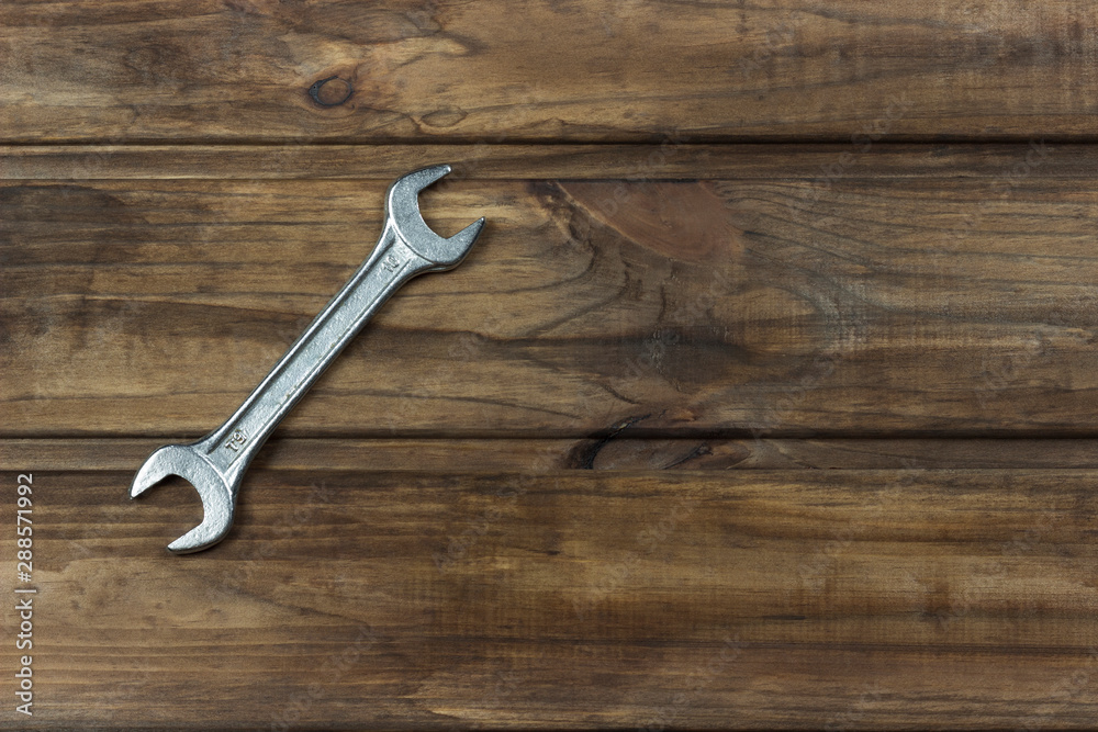 wrench on a wooden background, place for an inscription wrench on a wooden background, place for an inscription