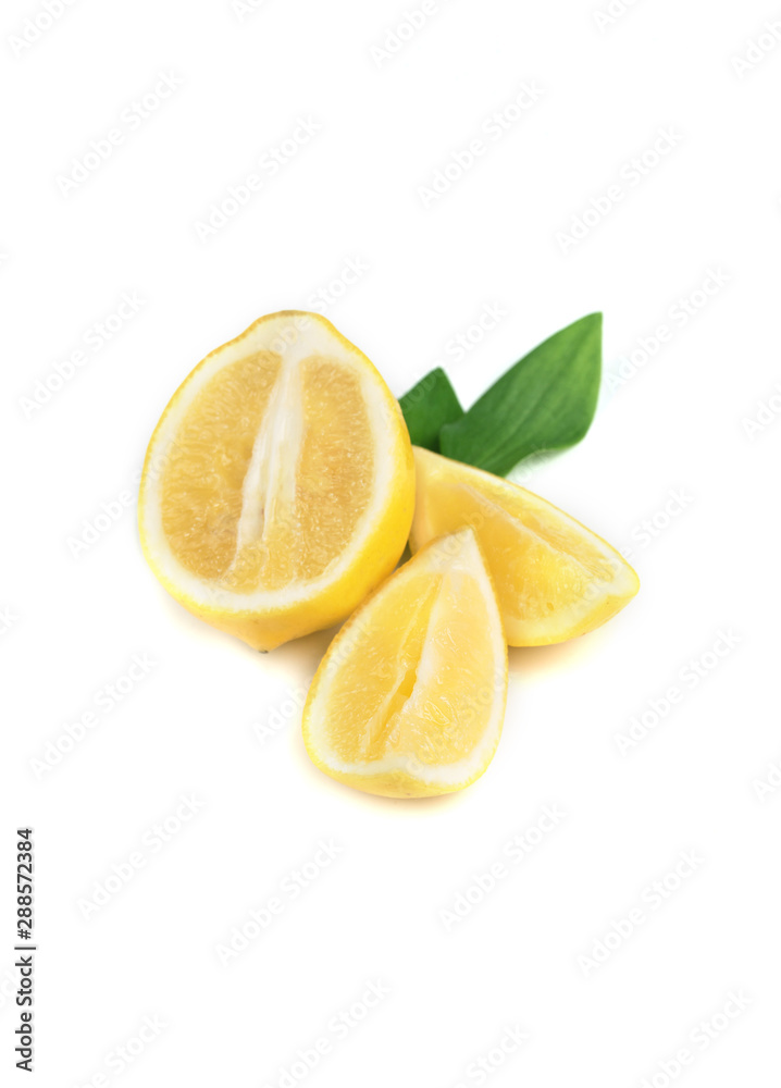 Ripe lemon with green leaves in white background