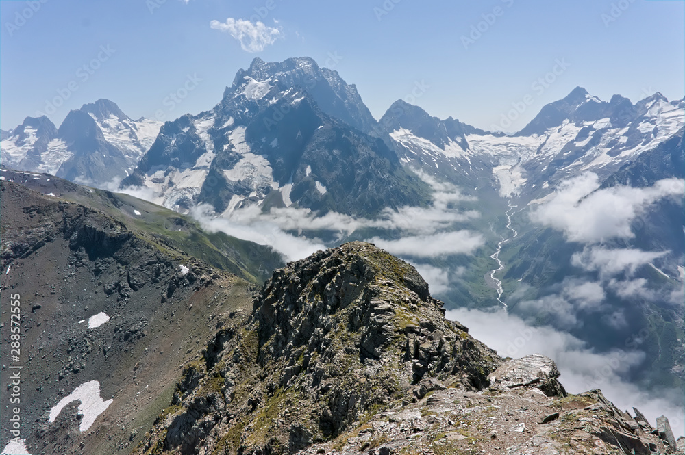 Mountain peak in black, covered with glaciers and snow. Dombay, Russia