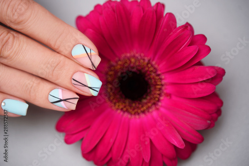 Great manicure with flower in beauty salon, close up