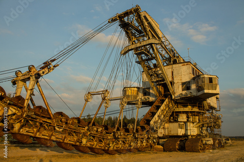 multi-bucket excavator giant at limestone quarry in summer day