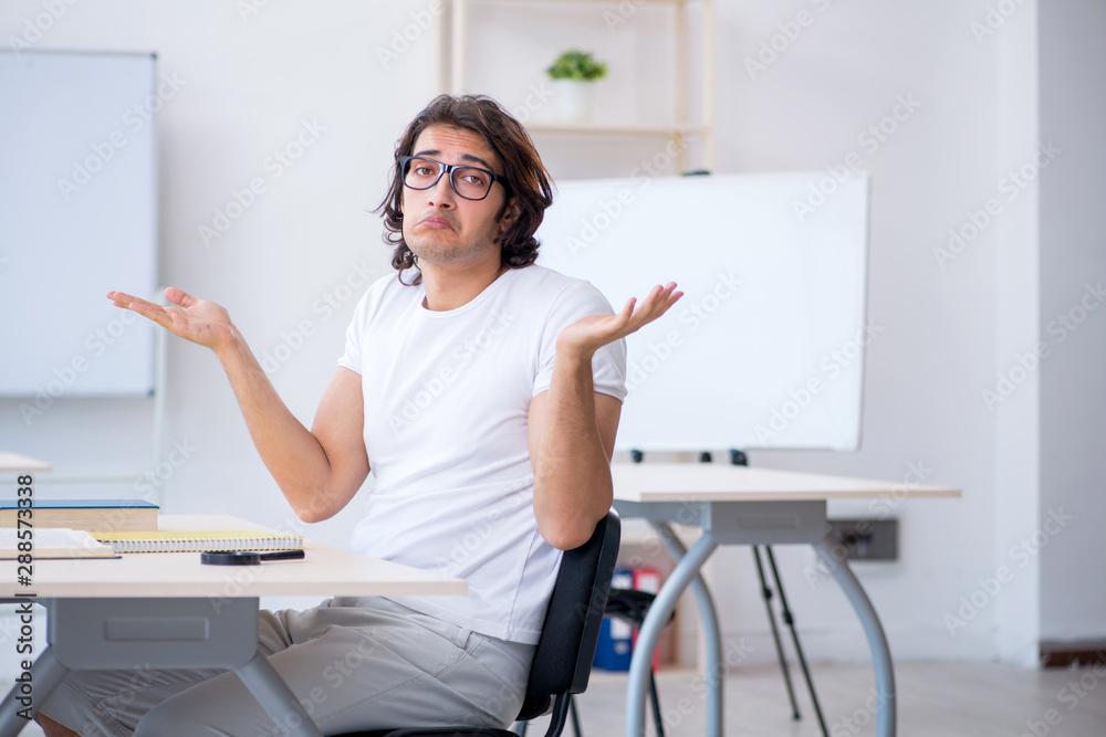 Young male student in front of whiteboard Young male student in front of whiteboard