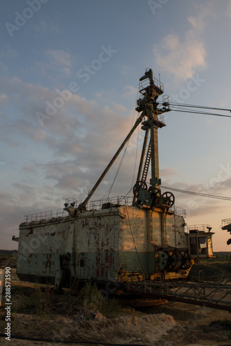 multi-bucket excavator giant at limestone quarry in summer day