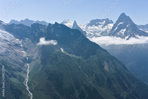 Mountain peak in black, covered with glaciers and snow. Dombay, Russia