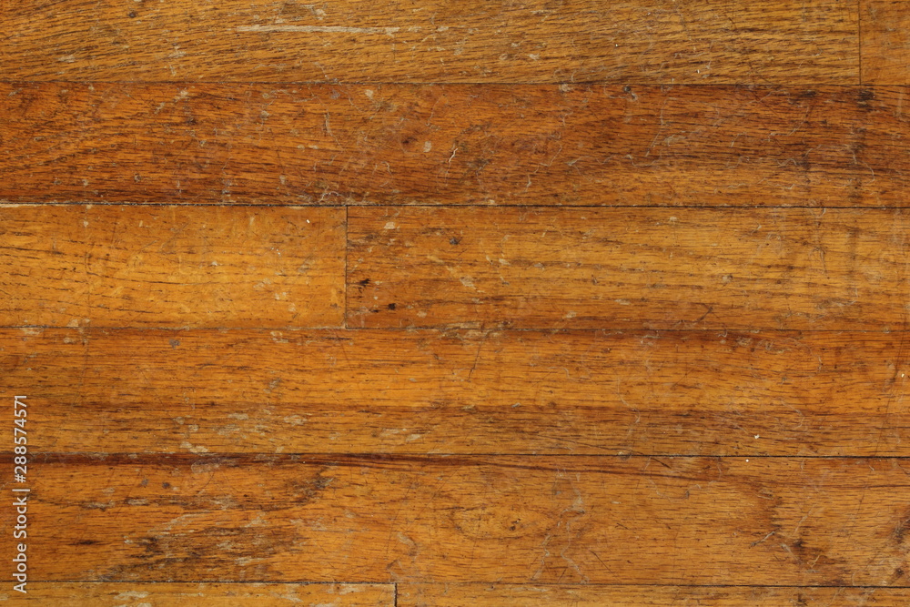 Fototapeta premium Weathered and damaged hardwood flooring, suitable for backgrounds or textures.