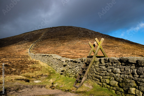 Stile over the Mourne Wall at Hare's Gap, Mourne Mountains, County Down, Northern Ireland. photo
