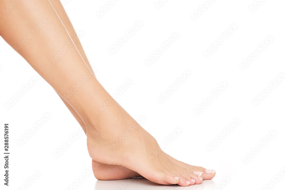 Tiny, female feet with delicate skin and perfectly done pedicure. Tiny, female feet with delicate skin and perfectly done pedicure.