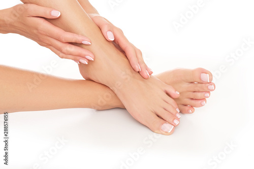 Studio shoot. Close up of perfectly done pedicure and manicure. Healthy and fresh skin is important for woman.