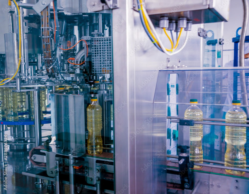 Bottling line of sunflower oil in bottles. Vegetable oil production plant. High technology. Bottling line of sunflower oil in bottles. Vegetable oil production plant. High technology.