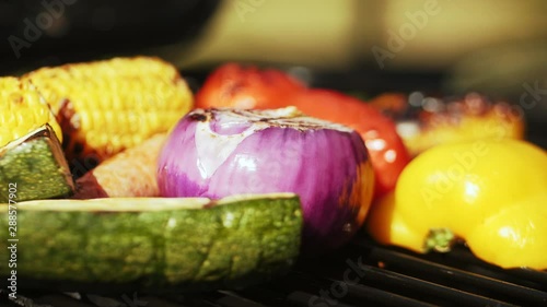 Vegeterain Barbecue on a sunny day in the garden. Colourful vegetables grilled on a BBQ. 4k videos photo