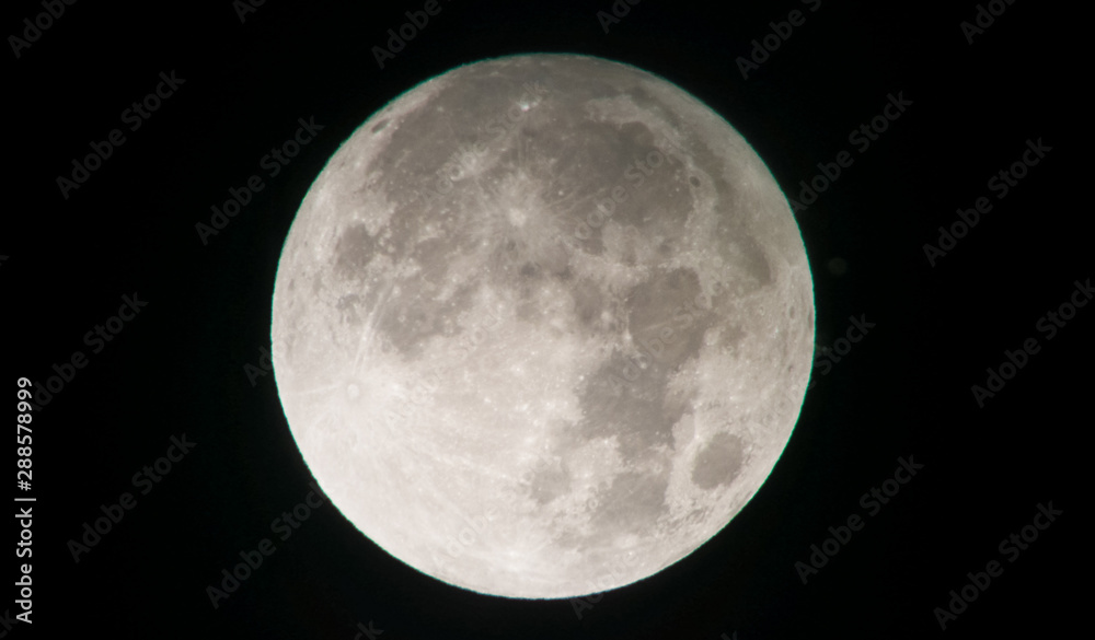 Zoomed photo of the full Moon, isolated on a black sky Zoomed photo of the full Moon, isolated on a black sky