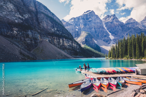 Fototapeta Colorful canoes in blue turquoise waters in Moraine Lake, Banff National Park, A