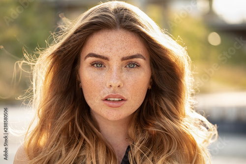 Beautiful woman with freckles on face. photo