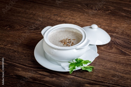 Vegetarian mushroom champignon cream soup on a dark table