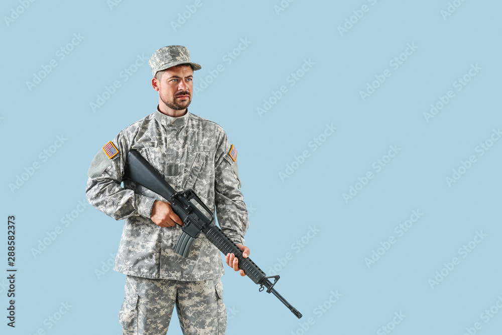 Soldier with assault rifle on color background Soldier with assault rifle on color background