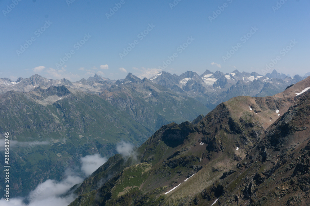 Panorama of the Caucasian ridge and Elbrus viewed from a peak near dombay, 2019