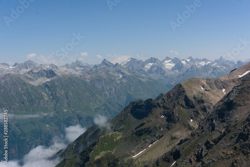 Panorama of the Caucasian ridge and Elbrus viewed from a peak near dombay, 2019 © Fizzl