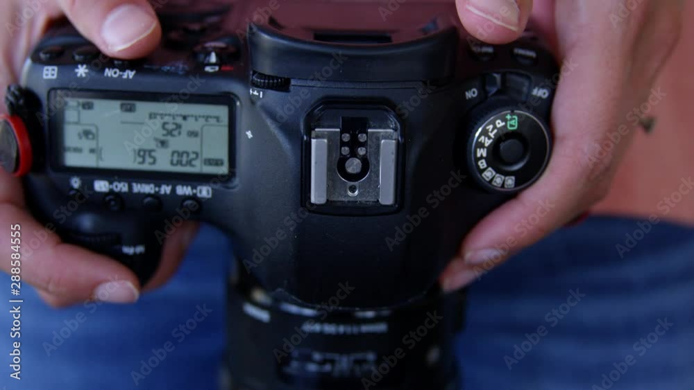 Female holding Digital SLR DSLR camera - close up Female holding Digital SLR DSLR camera - close up