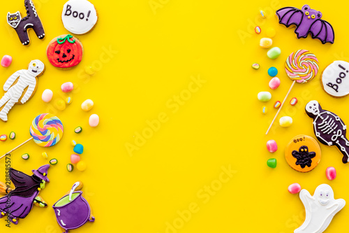 Frame from halloween figures on yellow background top view mockup