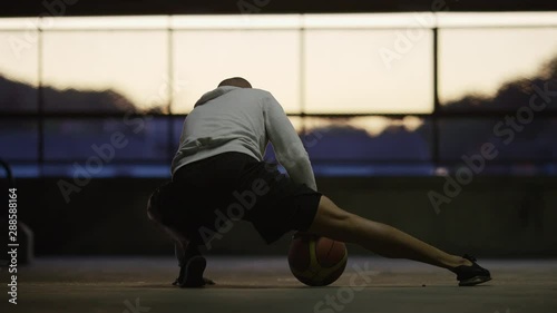Basketball player limbering up and stretching his legs photo