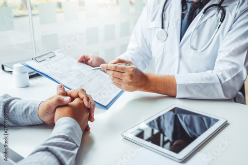 Doctors and patients consulting and diagnostic examining sit and talk. At the table near the window in the hospital medicine concept photo