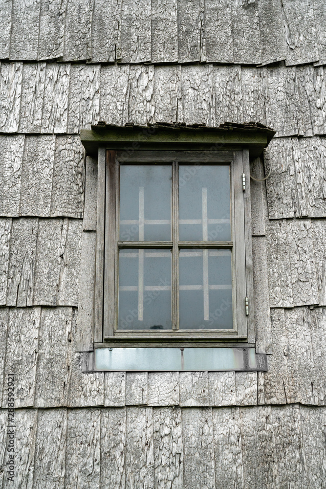 Wooden window on an ancient wooden chip windmill in Lazdininkai