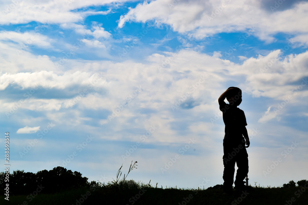 boy looking on a hill