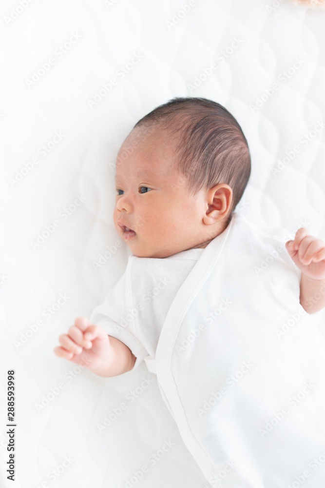 Baby lying on a crib